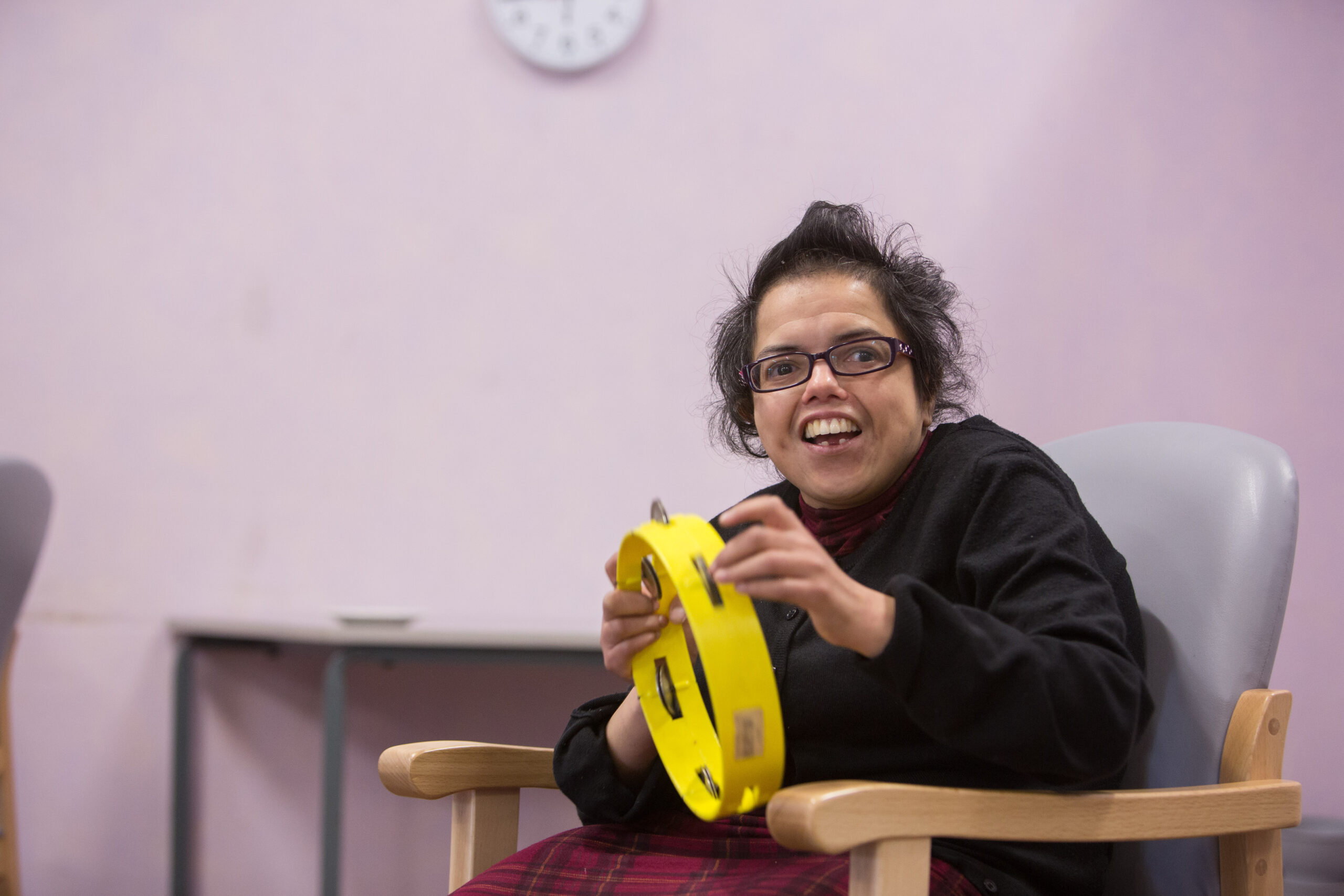 Young woman playing the tamborine