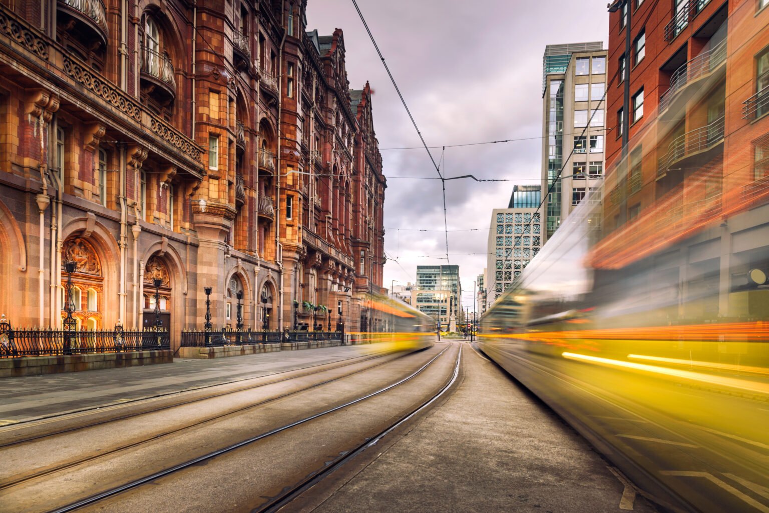 Image of trams driving through a city, they are motion blurred