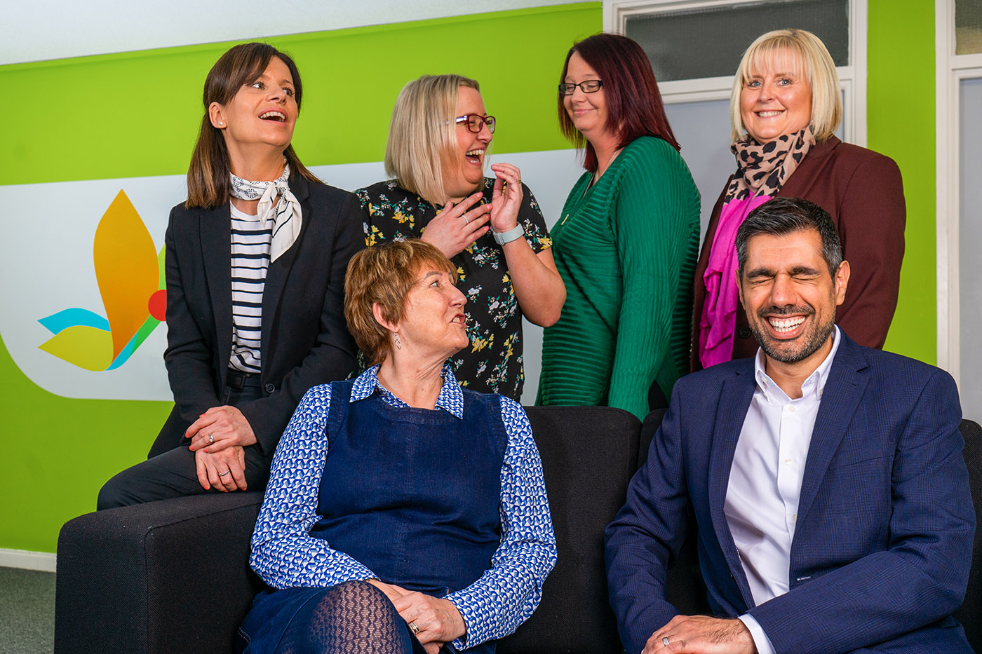 the leadership team sat in a group, laughing together