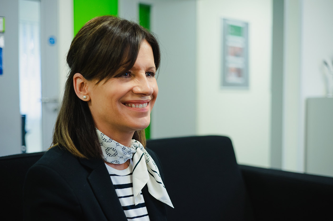 member of staff smiling at someone off camera