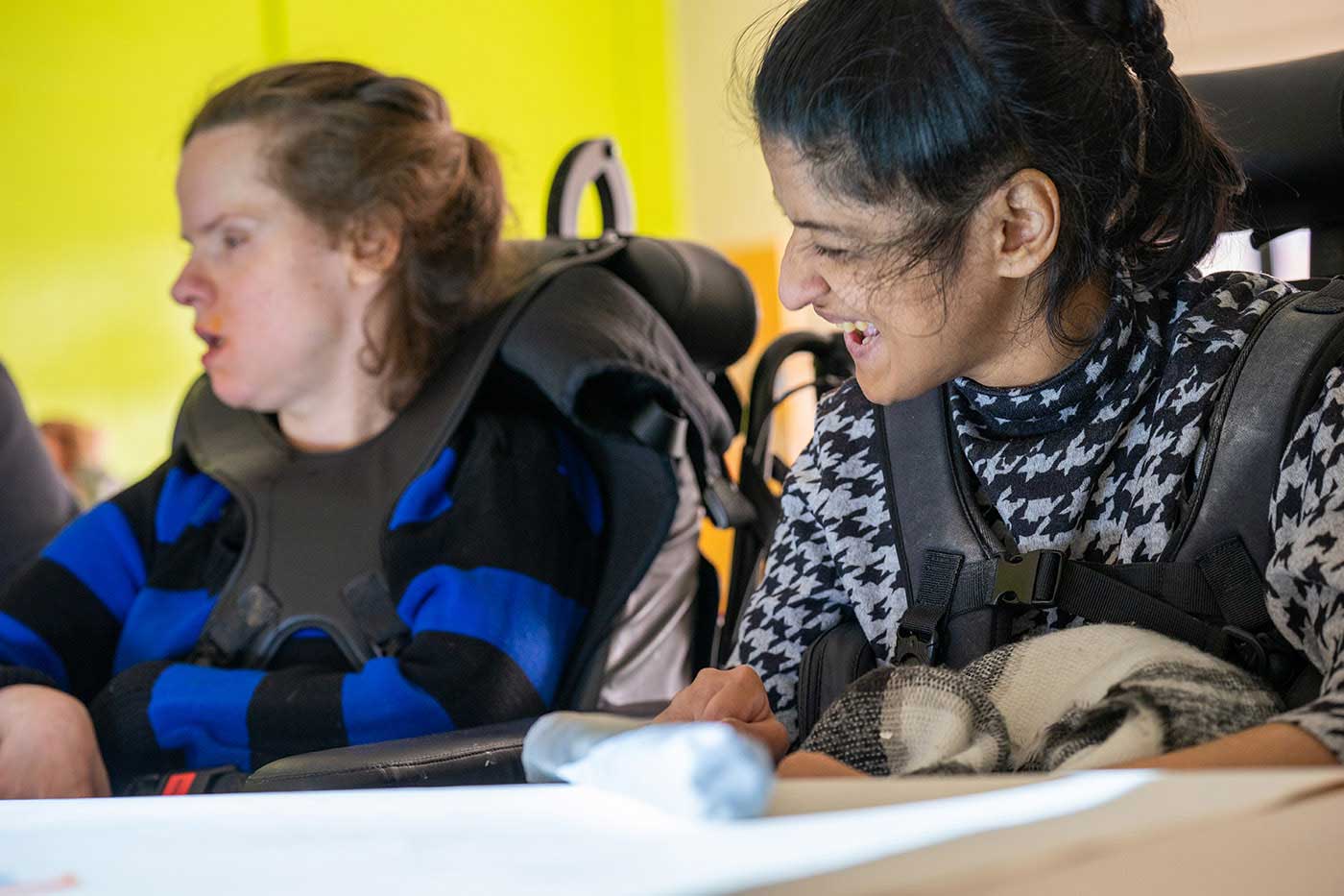 two young women in wheelchairs attending a day at the jubilee pool